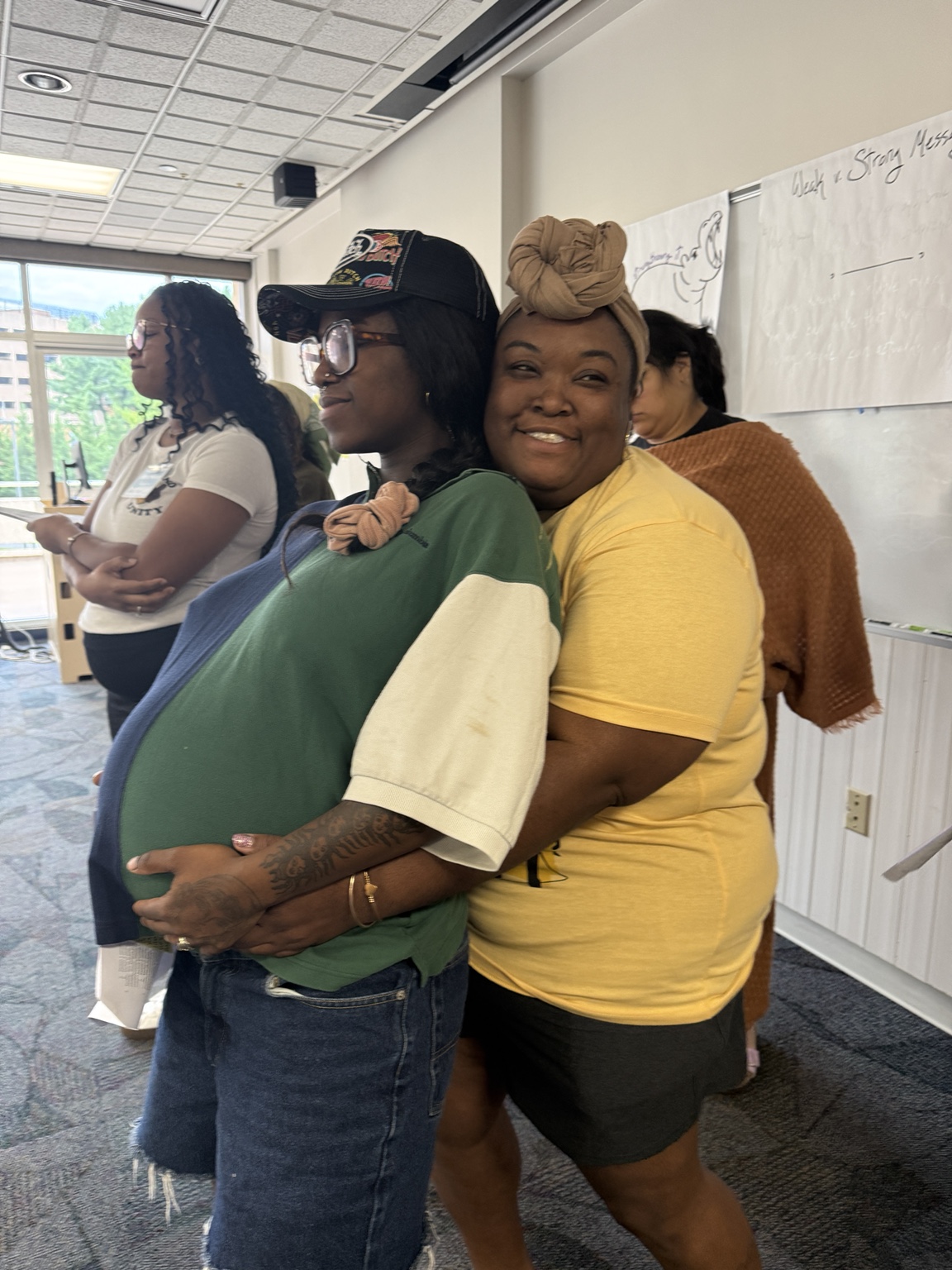 Chantel with a pregnant community member during a maternal health learning event
